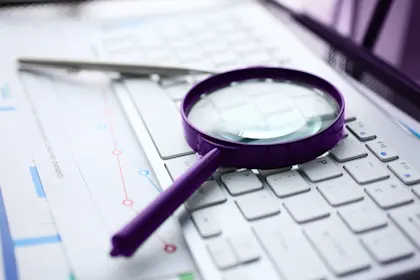 Magnifying glass on white keyboard