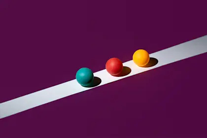 Multicolored balls on a white line