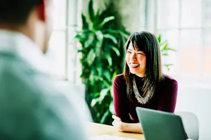 Smiling businesswoman leading project meeting