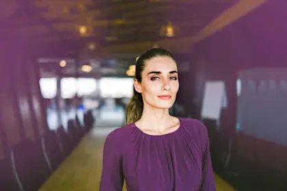 Confident young businesswoman in board room