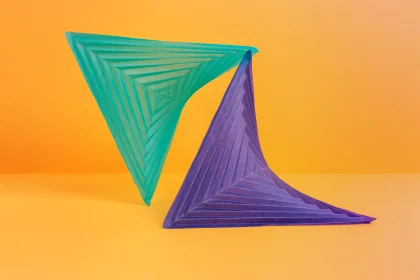 A green triangle balancing on a purple triangle