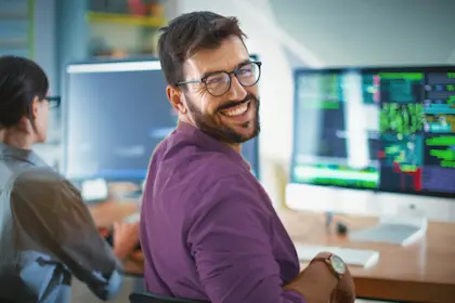 Man smiling at computer