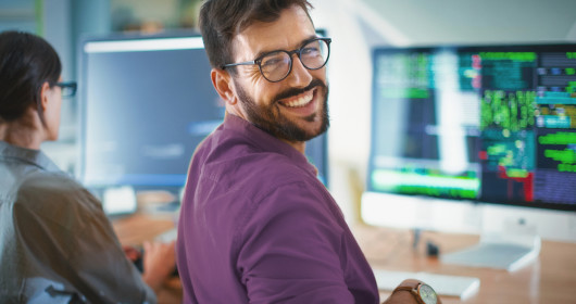 Man smiling at computer