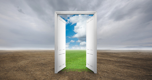Illustration of a door in the middle of a field on a cloudy day opened to a clear sky