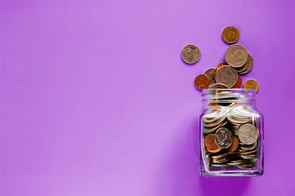 glass jar tipped over spilling coins