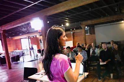 Woman speaking before a crowd
