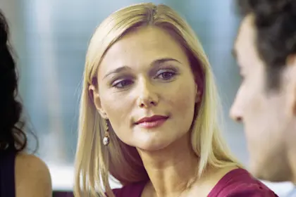 Side view of two women and two men sitting and talking