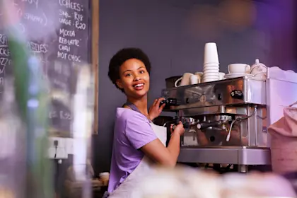Barista filling order at coffee machine