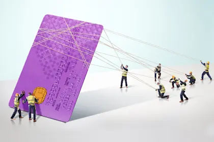 group of builders carrying a giant credit card