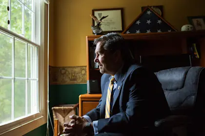 Man in suit, sitting and staring out the window