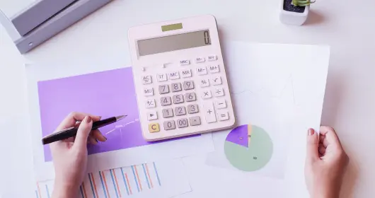 Calculator and graphs on a desk