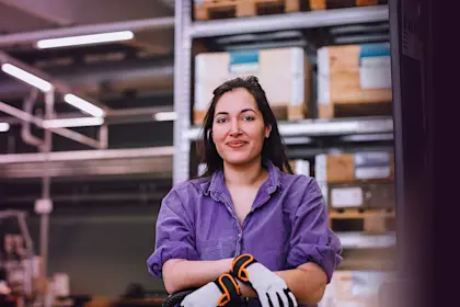 Woman in storage area wearing gloves