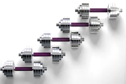 Five modern dumbbells lined up in a diagonal row