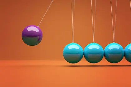 purple ball swinging into row of teal balls