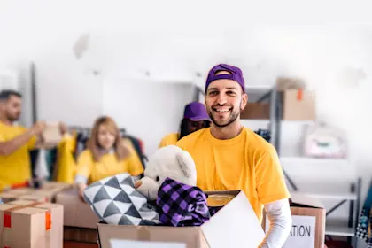 Man holding box of donated items