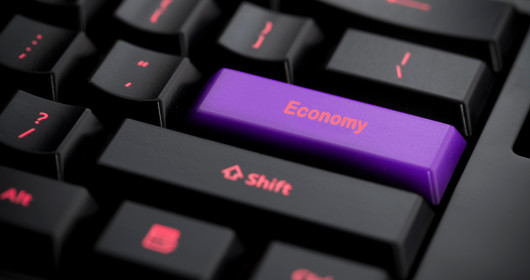Purple economy key on black keyboard.