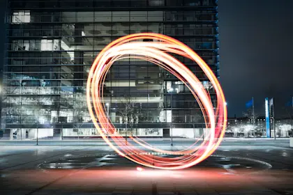Nighttime city scene with circular light sculpture