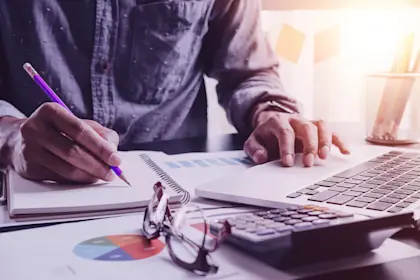 Close up photo of a businessman working at his laptop