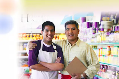Hispanic father and son in family owned bodega
