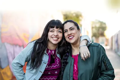 two young latina women smiling 