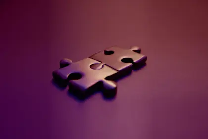 Puzzle pieces interlocking with purple background