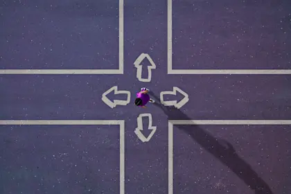 Person standing at four-way intersection