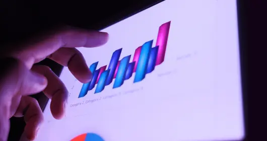 Close-up of hand in front of digital bar graph