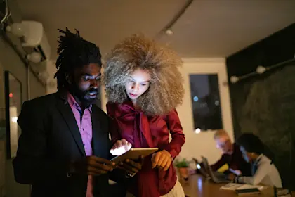 two young professionals using a tablet