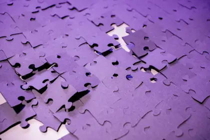 purple puzzle pieces falling apart