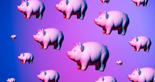 floating pink piggy banks on blue, purple and pink background