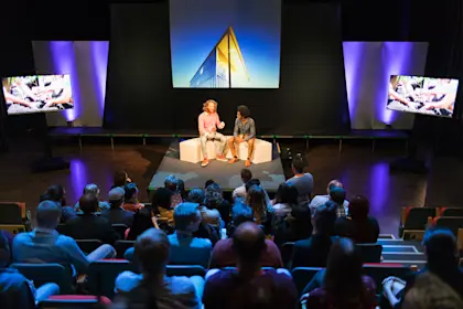 Audience watching speakers on stage