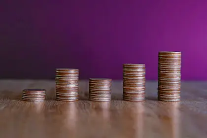 5 stacks of coins of various heights in a bar graph shape