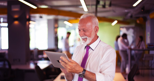 Mature adult man looking at tablet device