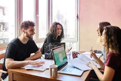 Four people talking and smiling