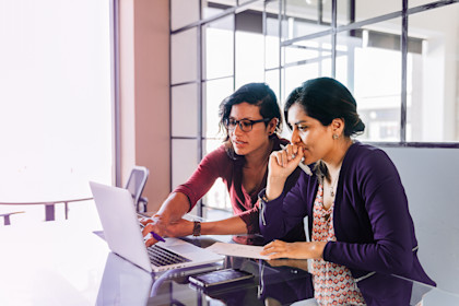 Two women looking at a laptop screen
