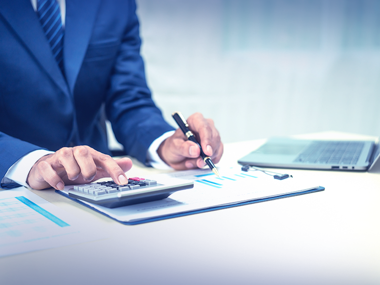 A businessman making calculations based on financial data