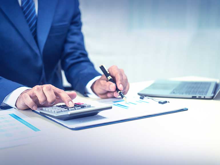A businessman making calculations based on financial data