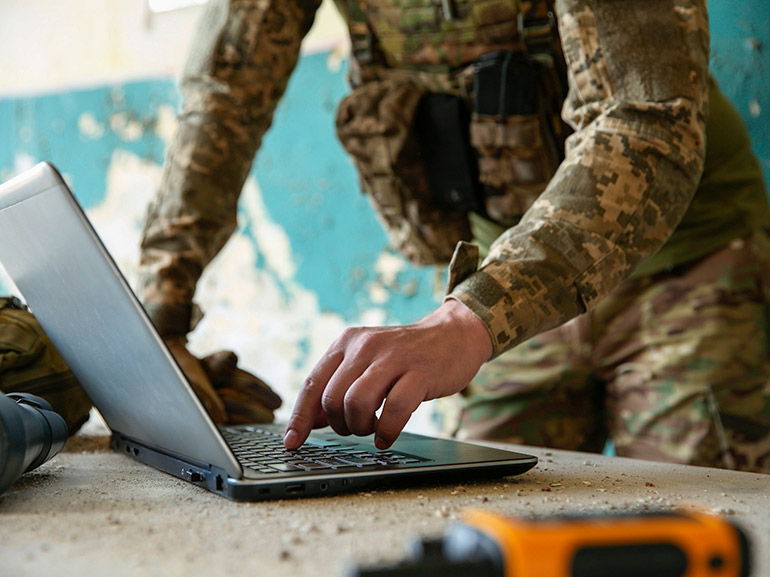 An image of a soldier using a laptop
