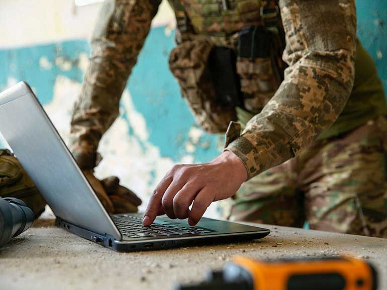 Imagen de un soldado utilizando un ordenador portátil