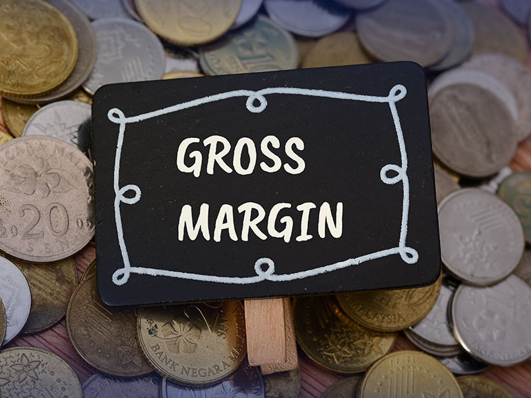 Gross margin sign on a background of coins