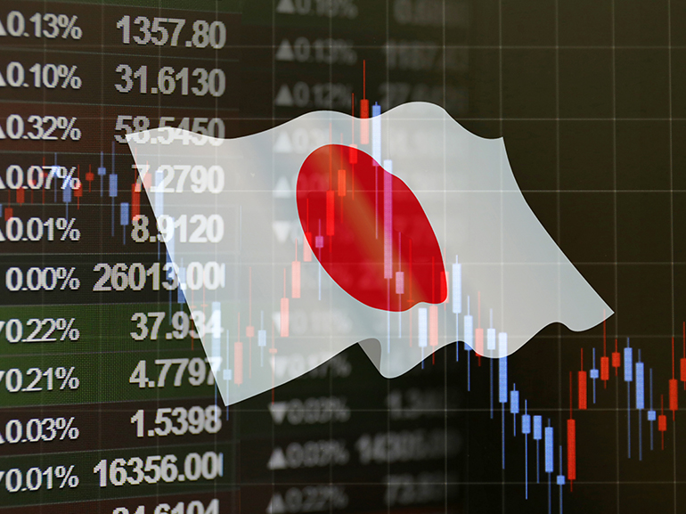 An image of trading charts with the Japanese flag in the background