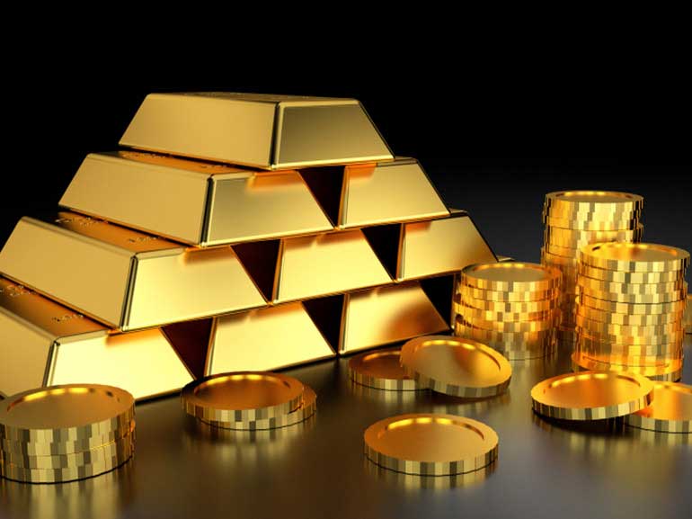 Gold bars and coin stacks on a dark background