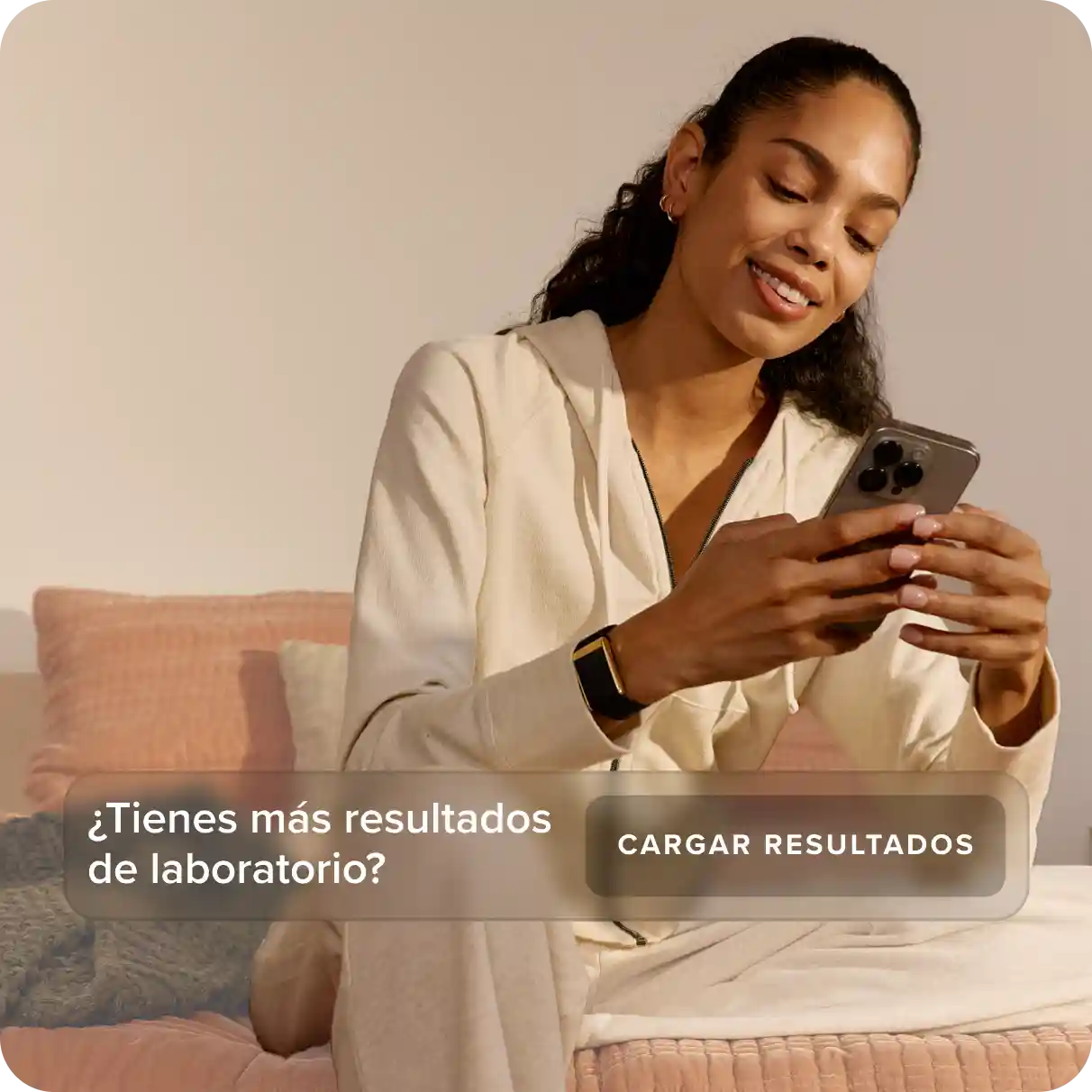 Woman wearing a WHOOP wearable while reviewing health data on her phone, illustrating lab result uploads and personalized health and performance insights.