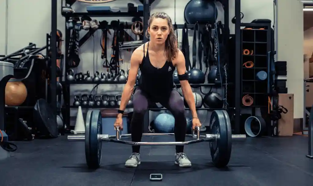 Kate Courtney lifting weights