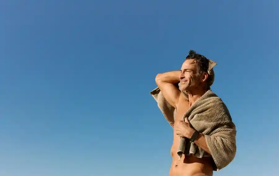 Man wearing a WHOOP wearable outdoors after training, highlighting heart rate monitoring, recovery tracking, and performance optimization in natural environments.