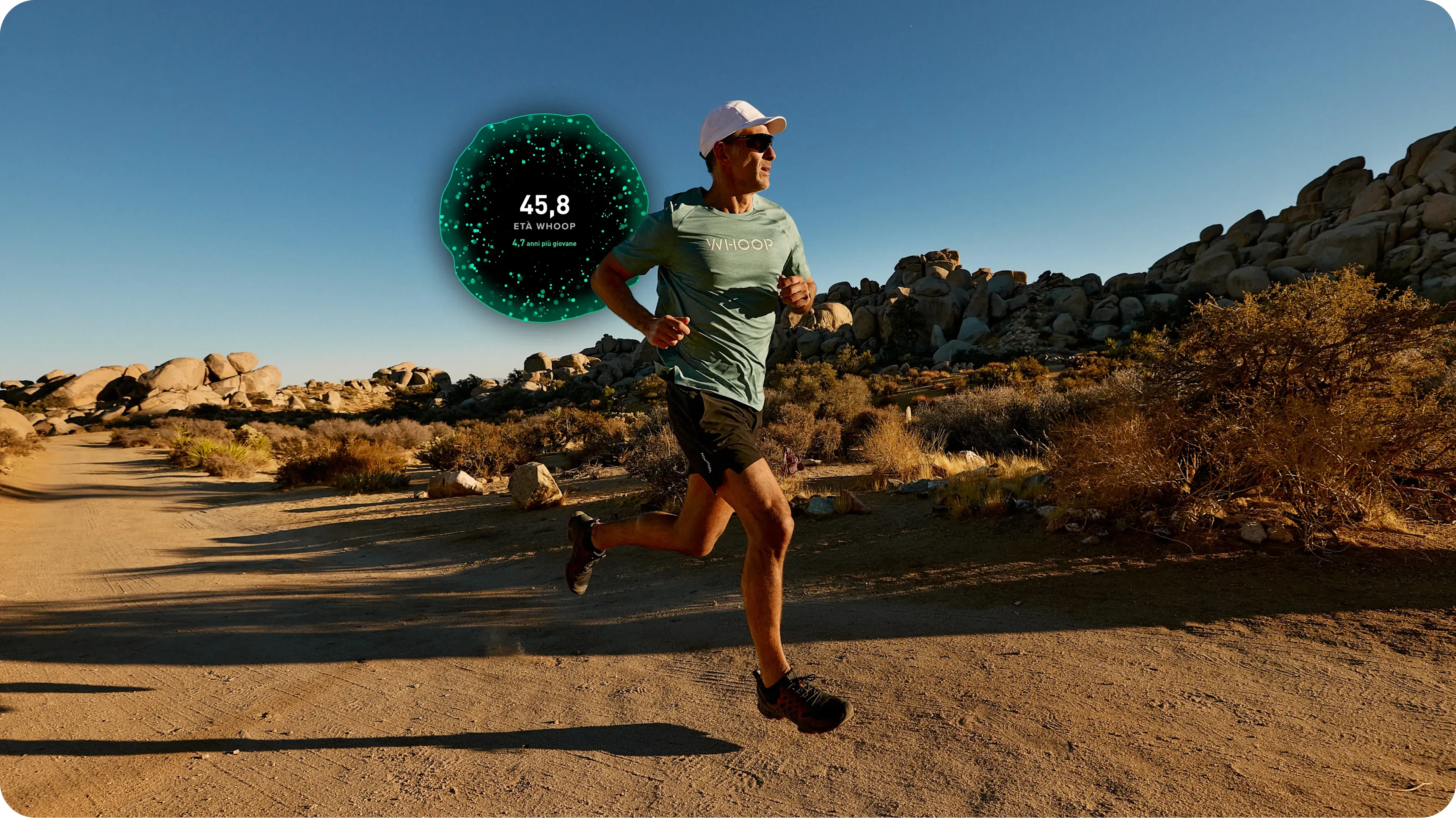 Outdoor running scene on a desert trail with a runner in WHOOP gear; a large WHOOP Age orb overlays the image displaying 45.8 and “4.7 years younger,” illustrating the WHOOP app’s biological-age metric tied to training, recovery, and long-term health.
