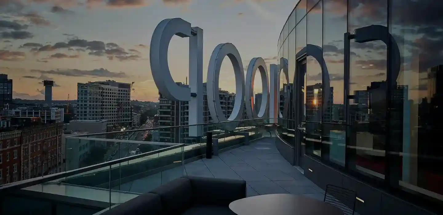 Rooftop view of the WHOOP office with large exterior signage overlooking the city at sunset, reflecting the skyline in the glass.