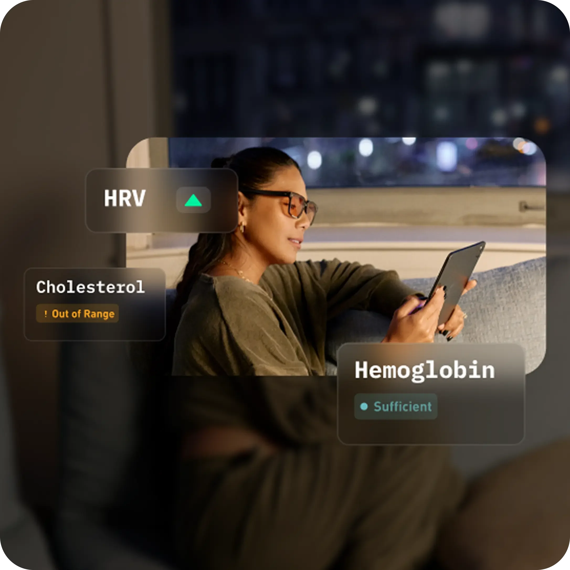 Person on a couch at night reviewing HRV, cholesterol out of range, and sufficient hemoglobin results in a health app.