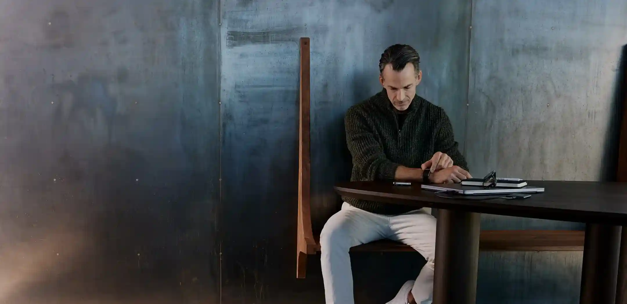 Man seated at a desk using a WHOOP wearable to take an ECG reading, highlighting heart health monitoring and advanced cardiovascular insights for everyday performance.