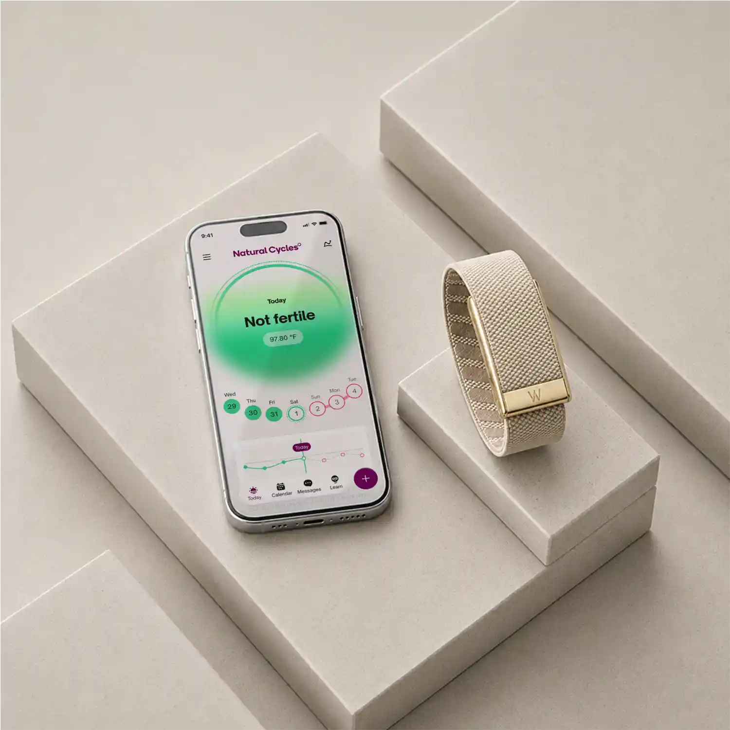 Natural Cycles app on phone beside gold WHOOP band on plinths. From Figma NC Landing Page_new_imagery.